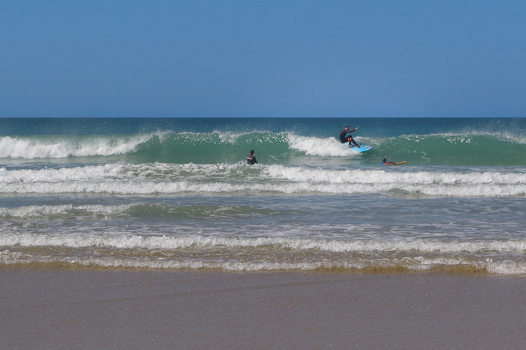 Picture of a surfer riding the wave in Conil, Spain
