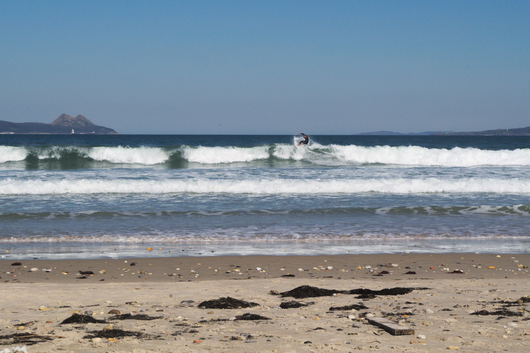 Picture of a surfer on Patos beach in Galicia