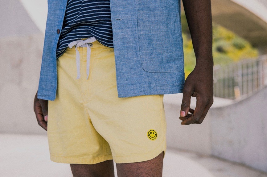 Picture of model presenting Outerknown Mr Porter collection of yellow shorts and denim shirt