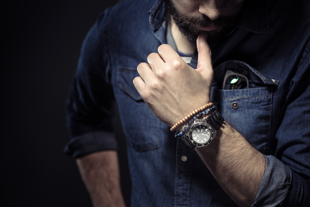 man wearing a jeans shirt and seiko diver watch